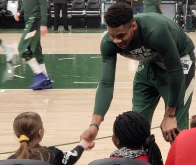 basketball player interacting with child