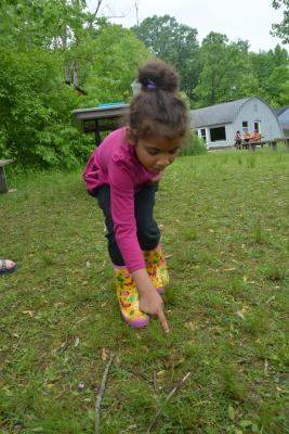 little girl pointing at ground