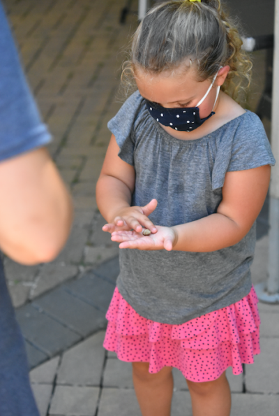 little girl holding rock