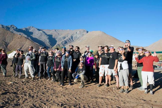 group of people watching eclipse