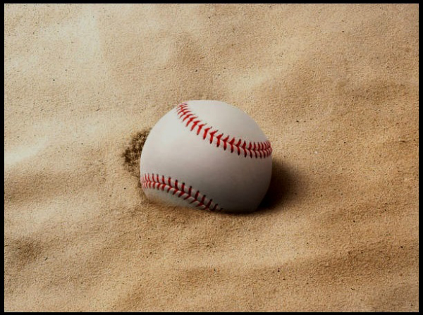 A baseball on the beach