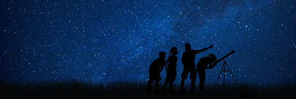 starry night sky with silhouettes of people stargazing