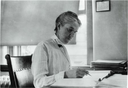 woman writing at desk